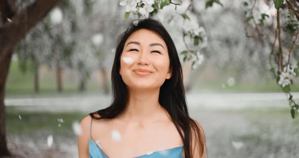 Woman in Blooming Apple Trees