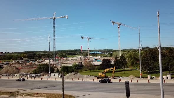 Cinematic drone shot of cranes on a construction site.