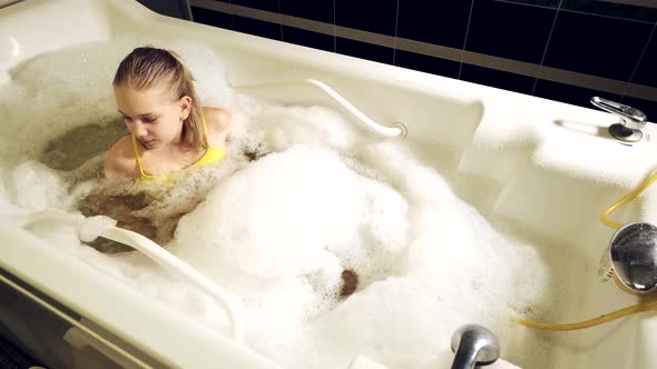 Little Girl Takes the Procedure in a Mineral Bath