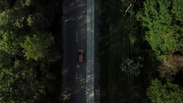 Drone Point of View Tracking Mode Aerial View Flying Over Two Lane Countryside Forest Road with