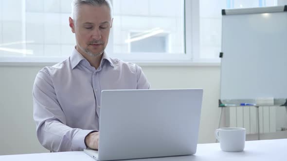 Headache Stressed Businessman Working on Laptop