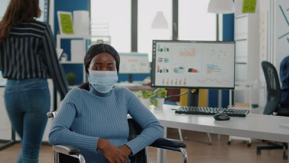 Portrait of African Woman with Protection Face Mask Looking at Camera