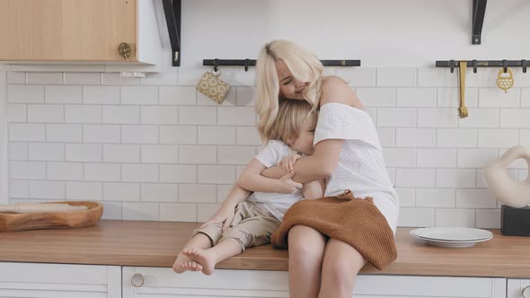 Blonde Woman with Her Son in the Kitchen