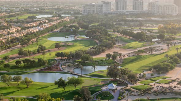 Aerial View to Villas and Houses with Golf Course with Green Lawn and Lakes Timelapse