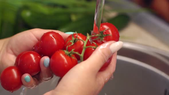 Washing Tomatoes Under Running Water in a Professional Kitchen