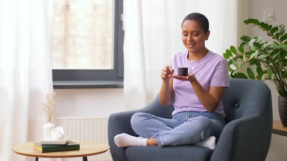 African American Woman with Smart Speaker at Home