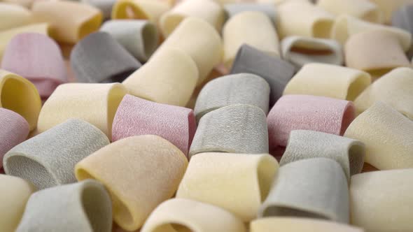 Uncooked multicolor dry italian pasta close up