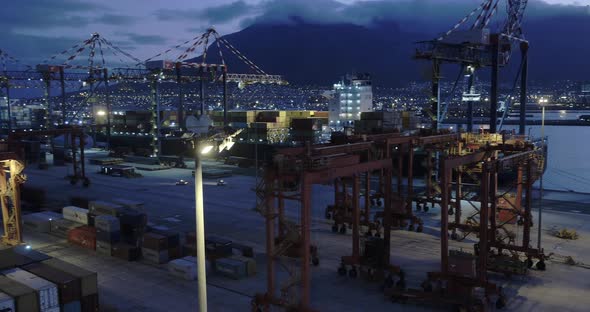 4k Drone Shot of Table Bay Harbour steel Containers and Gantry Cranes with Table Mountain, Cape Town