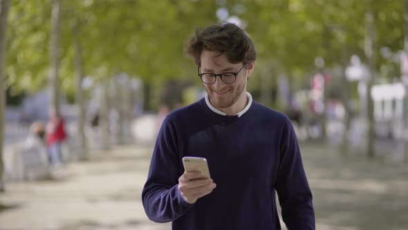 Smiling Man Using Mobile Phone Outdoor