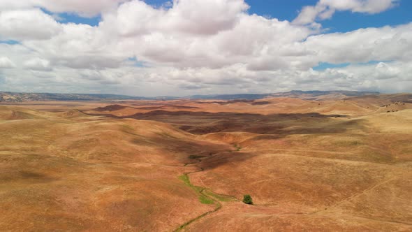 Hyper Lapse of Clouds Over Yellow Dry Grass Hills