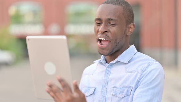 Outdoor Portrait of Video Call on Tablet By Attractive African Man 