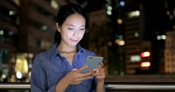 Woman looking at mobile phone in Hong Kong 