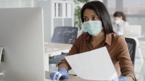 Video of woman working in an office during a pandemic. Shot with RED helium camera in 8K