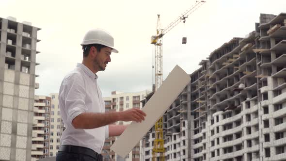 Portrait of a Successful Young Engineer Architect Builder Businessman Wearing a White Helmet in a