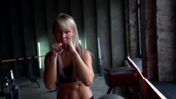 Young Pretty Woman Is Training in Gym, Workout and Box Fighting for Strong and Endurance