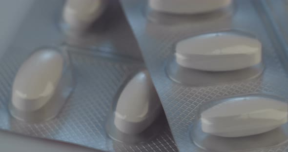 Prescription drugs - Capsules, pills, tablets on reflective background