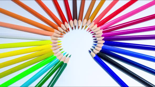 Creative and bright stop motion, colored pencils line up in a circle shape creating a rainbow.