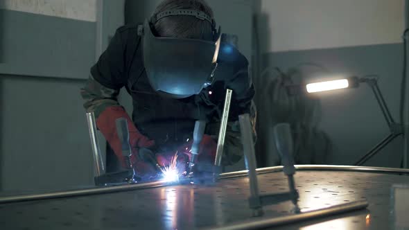 Sparks during welding work in the metal industry. Slow motion.