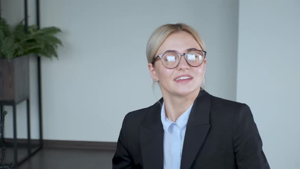 Girl looks into the camera and talks. Communicates. Closeup portrait of smiling 