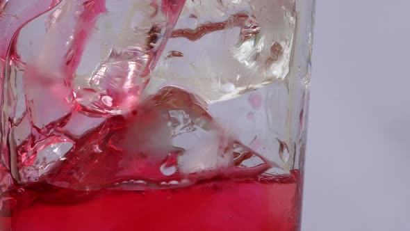 Red soft drink's bubble in a glass.