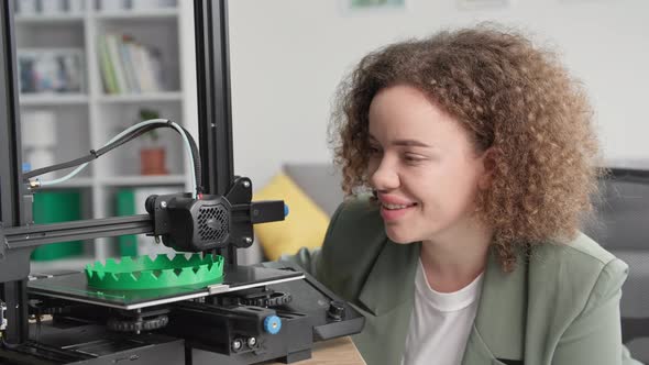 Modern Technologies Charming Woman is Watching Work of 3d Printer Smiling and Looking at Camera