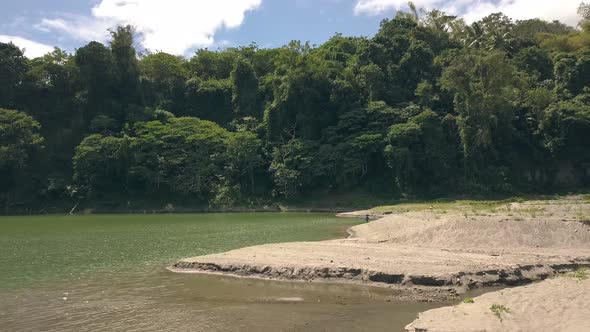 Flying Over the Camping with Resting Family on the Lake Among Tropical Mountains.