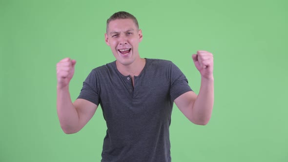 Portrait of Happy Young Man Getting Good News