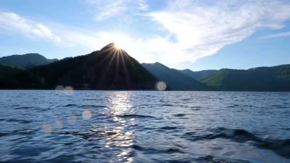 Mountain lake with big waves caused by wind. Beautiful mountain lake. Sailing on a mountain lake.