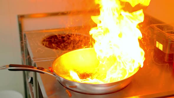 CU Fresh Vegetables Flare Up in a Frying Pan The Cook Adds to the Frying Pan Another Bell Pepper a