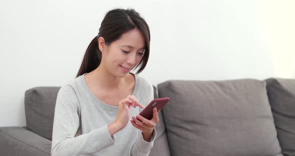 Woman using smart phone at home