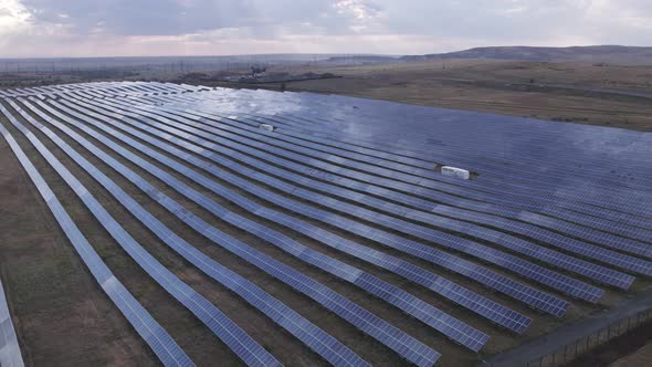 Large Solar Power Plant in the Middle of Field Producing Clean Renewable Energy Aerial View