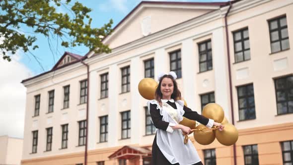 Happy Russian Schoolgirl with Balloons on Graduation Day