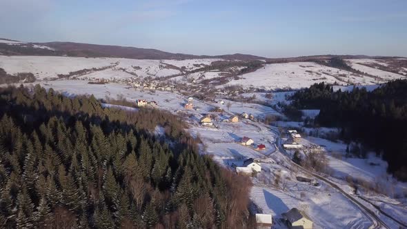 Aerial View of Winter Landscape with Snowy Hills and Forest on the Mountains