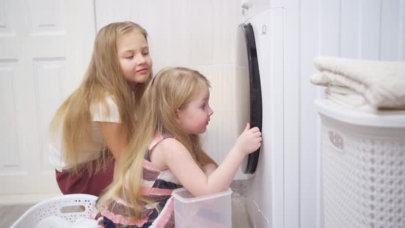 Cute Little Girls Open the Door and Take Out Laundry in the Washing Machine