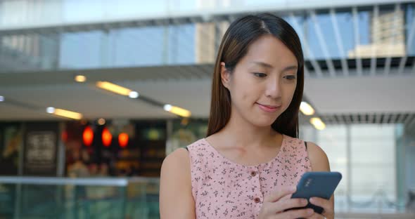 Woman use cellphone in shopping center