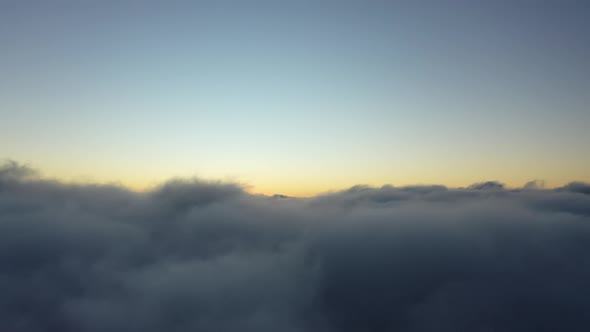 Above the clouds. Sunrise foggy morning.