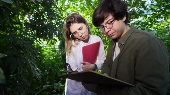 Young Agricultural Engineers Working in Greenhouse