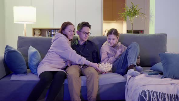 Family of One Parent Son and Daughter Watching TV