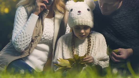 Daughter Playing With Parents in Autumn Park, Counting Leaves, Practicing Math