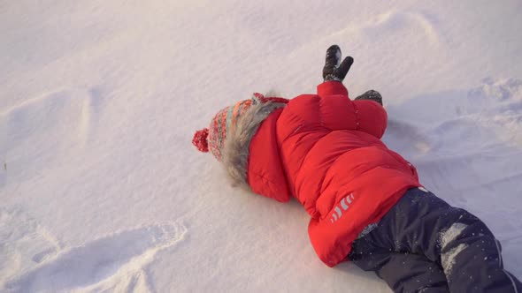 Little Boy Playing in Snow with His Mother. Slowmotion Shot