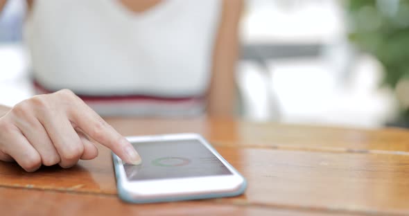 Woman typing on mobile phone at outdoor 