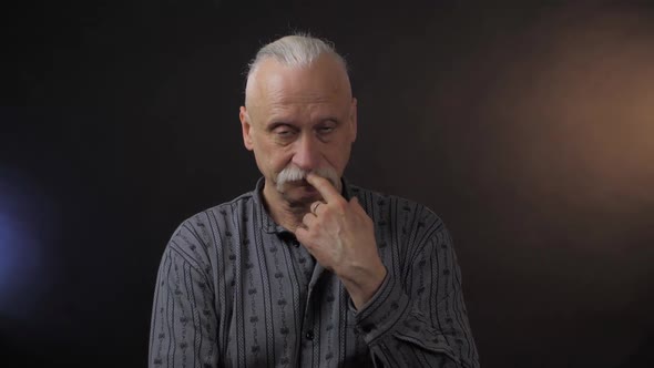 Bald Senior Man Moves Hands and Spreads Arms Above Head