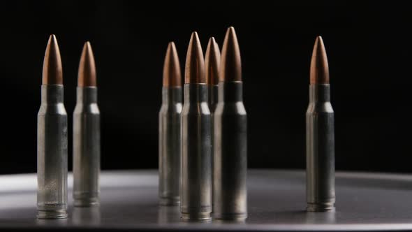 Cinematic rotating shot of bullets on a metallic surface - BULLETS 