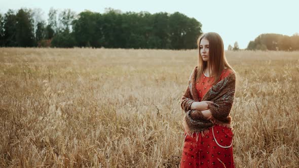 Young Farmer Girl Walking Through Wheat Field at Sunset. Modern Farming, Happy Youth and Profession