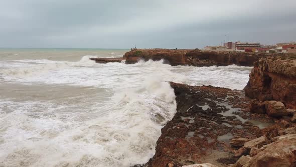 Crushing Waves Against Tall Rocks Along the Coastline.