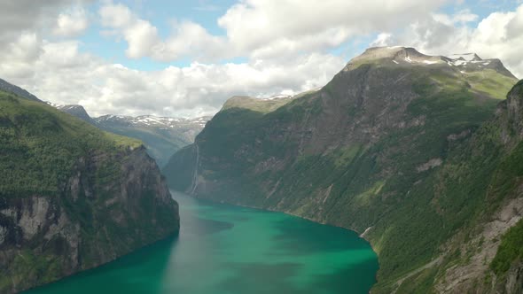 Picturesque Panorama Of Geiranger Fjord And Skagefla Mountain Farm On Steep Hillside From Ornesvinge