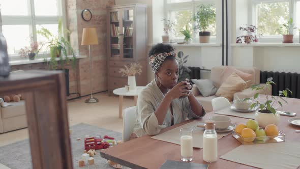 Black Woman Enjoying Breakfast in Loft Apartment