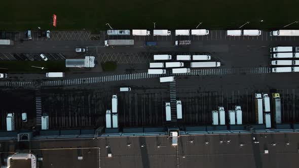 Trucks Ready To Load and Unload at Huge Warehouse Aerial View