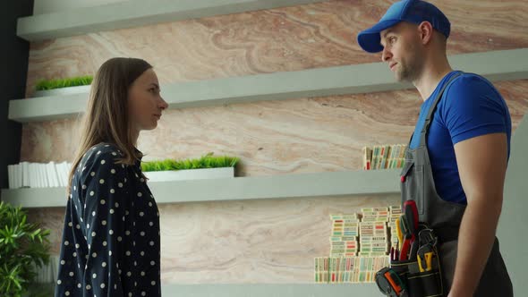 Woman Shaking Hands with Handyman