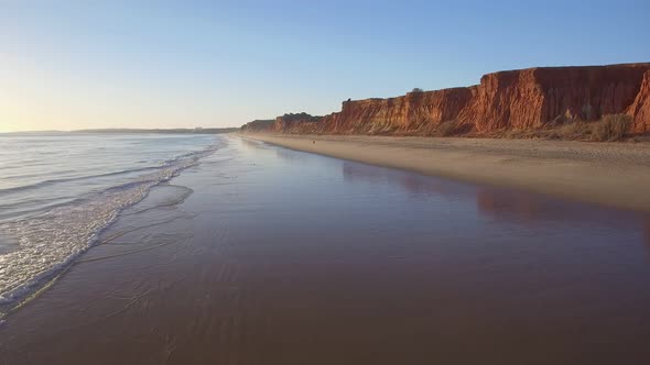 Aerial Flight Over a Beautiful Evening Beach at Low Tide and a Mirrored Surface That Reflects the